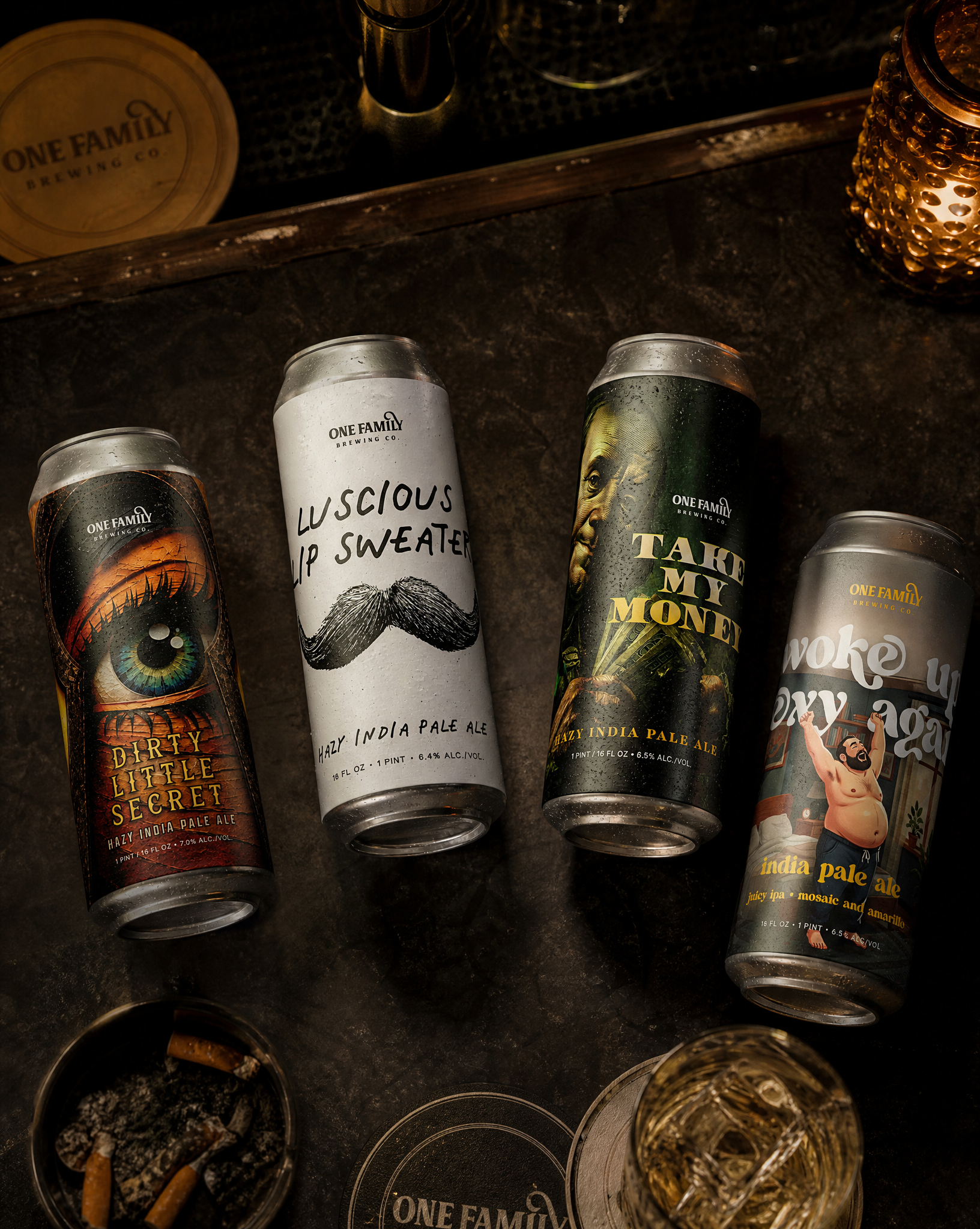 One Family Brewing beer cans on a warm bar countertop